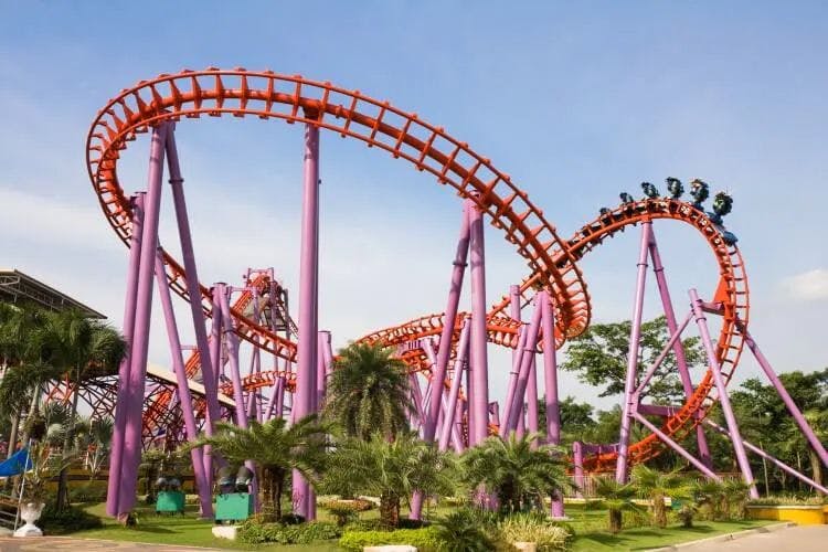 A large roller coaster with people riding it
