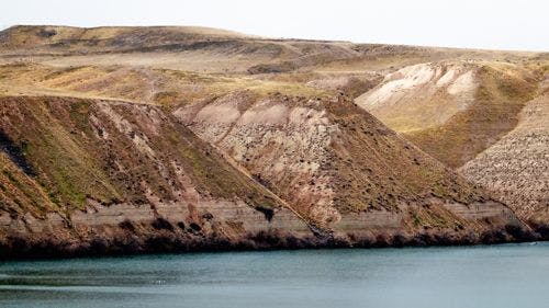 Sedimentary cliffs over a lake at Hagerman Fossil Beds State Park