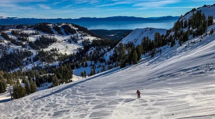 A person skiing down the side of a snow-covered mountain in Lake Tahoe