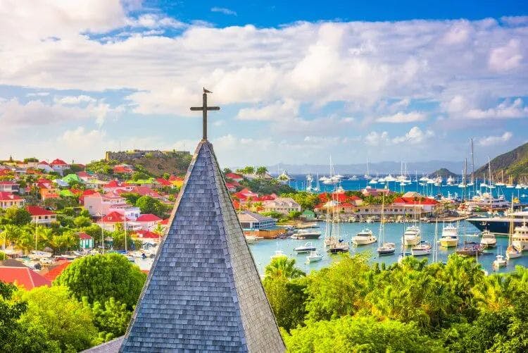 Church steeple in St Barthelemy with Gustavia city in the background