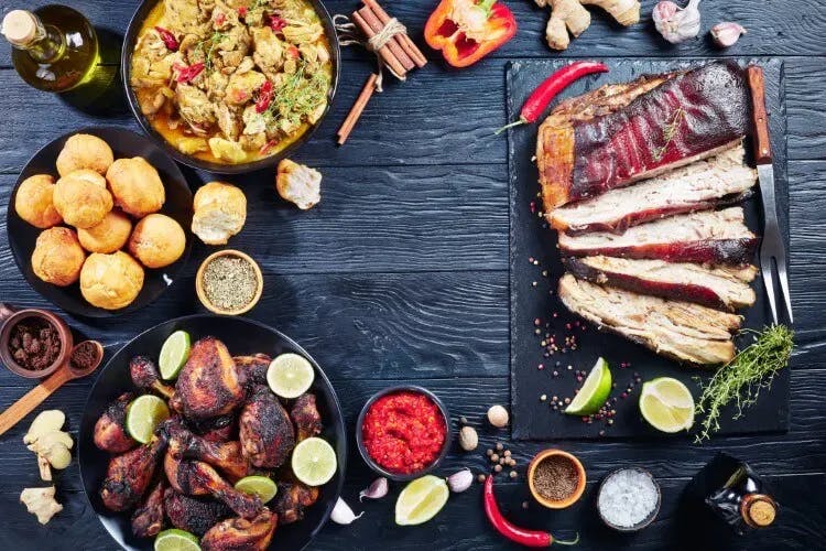 Ariel shot of barbeque style food on a black wood table