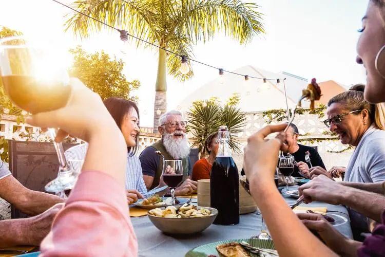 A group of people sitting around a restaurant table enjoying a shared meal