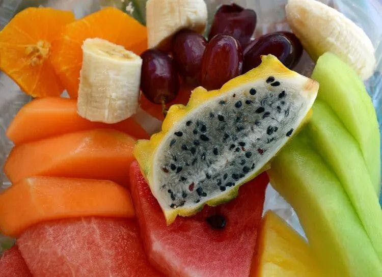 Tropical fruit plate with bananas, melon, and dragon fruit