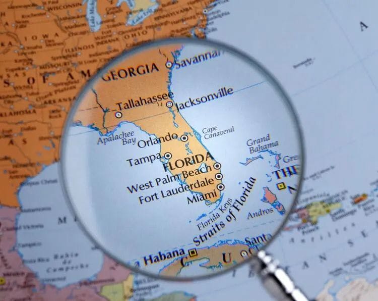 A magnifying glass over a map of Florida