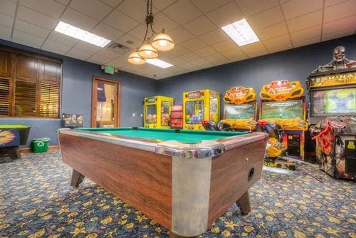 Paradise Palms game room with pool table and arcade machines