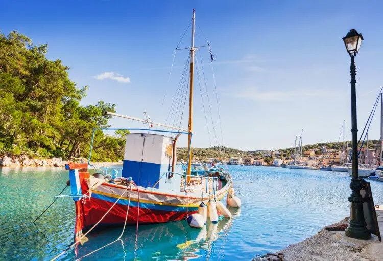 Traditional small fishing boat moored in a natural cove harbor