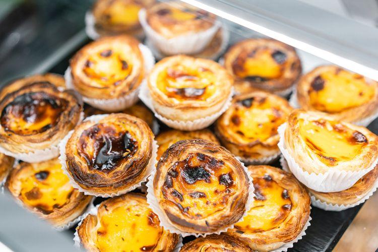 A pile of Pastel de Nata - Portuguese custard tarts