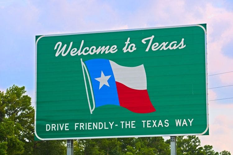 Welcome to Texas sign, with Texan flag on a green background