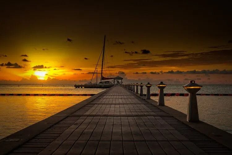 Sunset over a long wooden pier