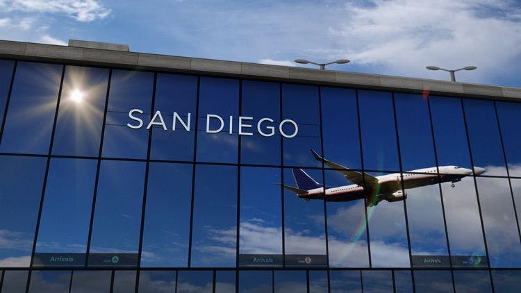 A passenger plane reflected in the windows of San Diego Airport
