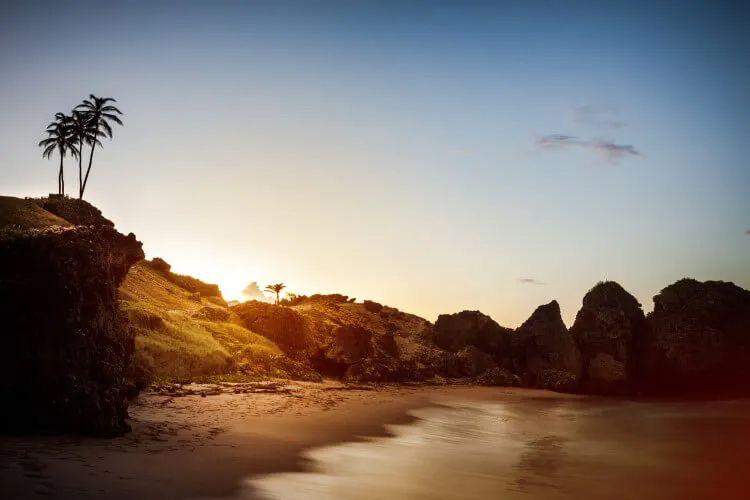 Sunset over a white sand beach in Barbados