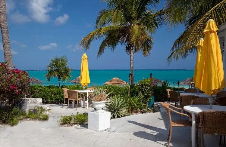 A restaurant by the Caribbean Sea with yellow parasols