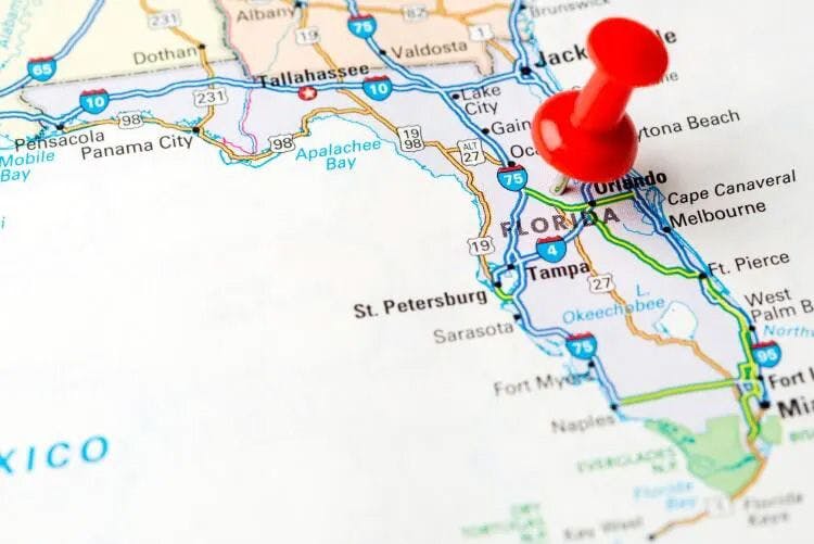 A map of Florida with a red push pin in Orlando