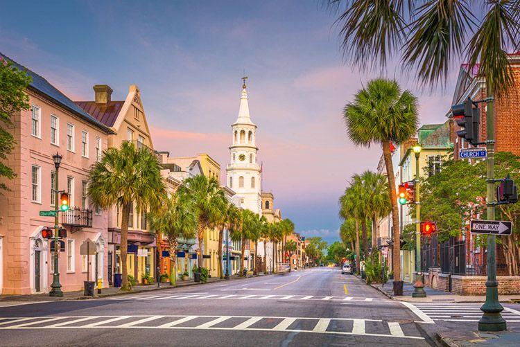 The main street in Charleston, South Carolina, a tree-lined avenue with old-style buildings and a tall white spire
