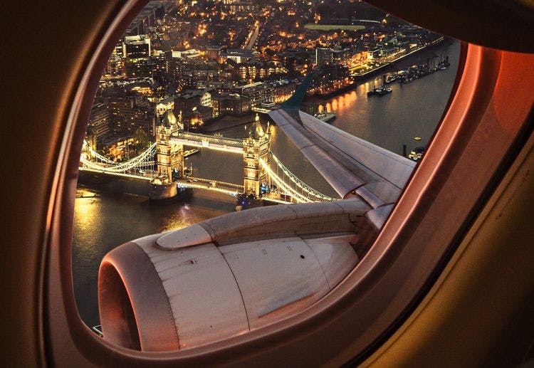 View of London at night out the window of a plane