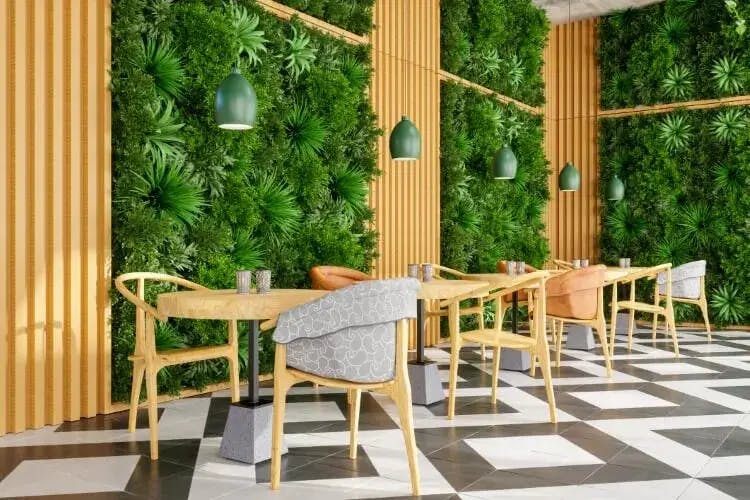 A restaurant in Cape Coral with living walls and tables for two set up