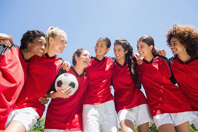 A woman's soccer team in red jerseys