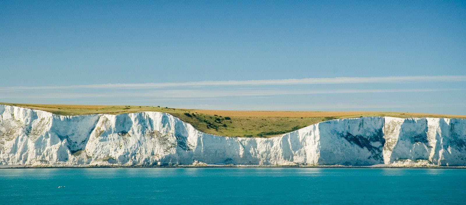 White cliffs of Dover, a line of tall chalk cliffs with calm blue sea