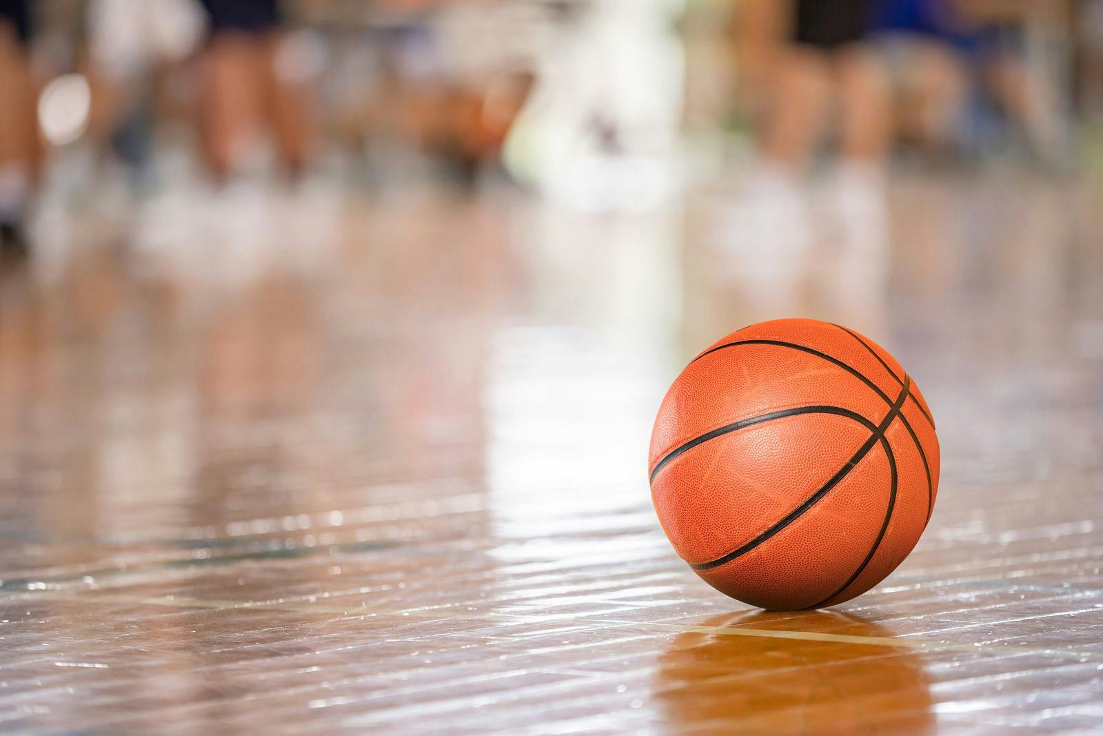 A basketball on a wooden floor