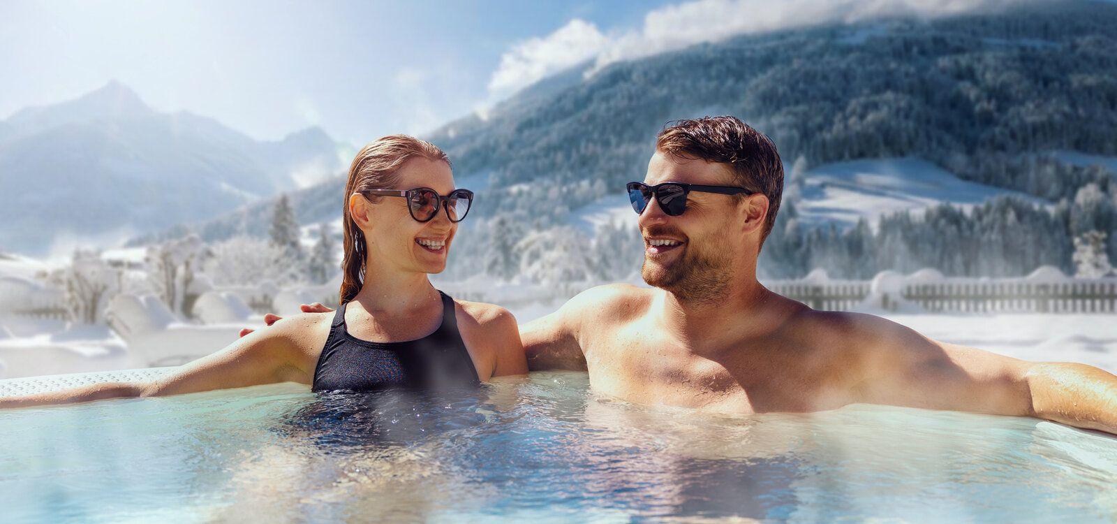 Val d'Isere chalet with hot tub, couple enjoy a scenic hot soak, Top Villas