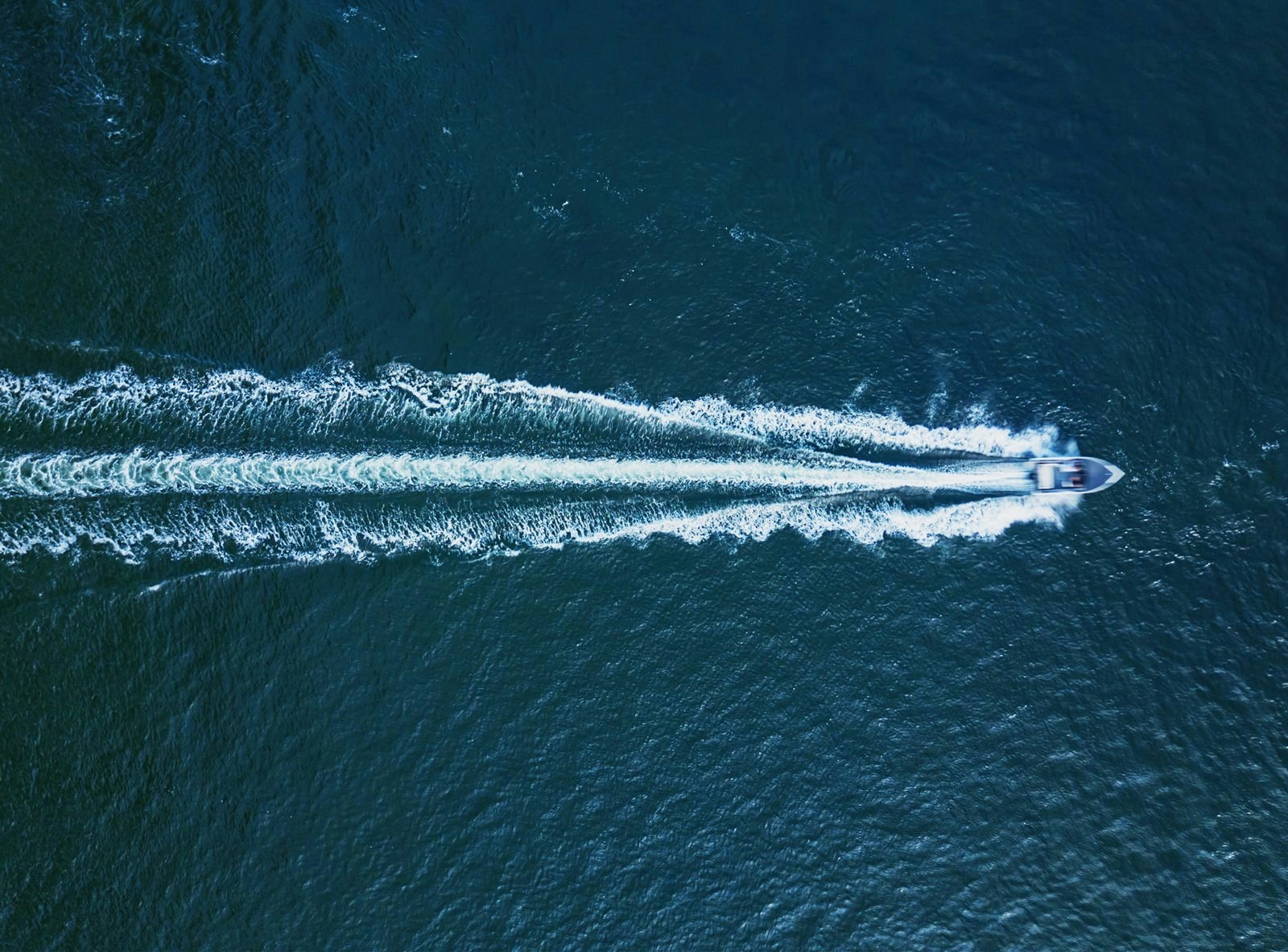 Ariel shot of a speedboat moving through the sea