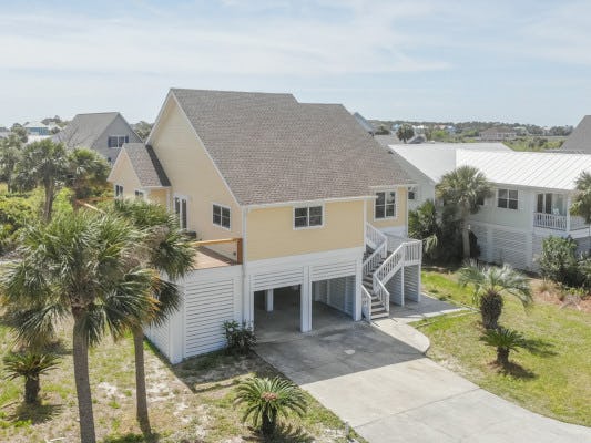 Sea Islands 12 South Carolina vacation rental yellow home with white wooden balconies