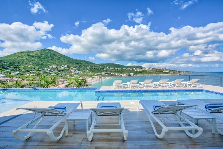 loungers on a deck with pool overlooking saint martin and ocean