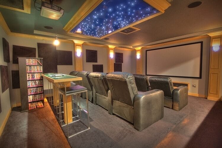 movie room with starry night style ceiling