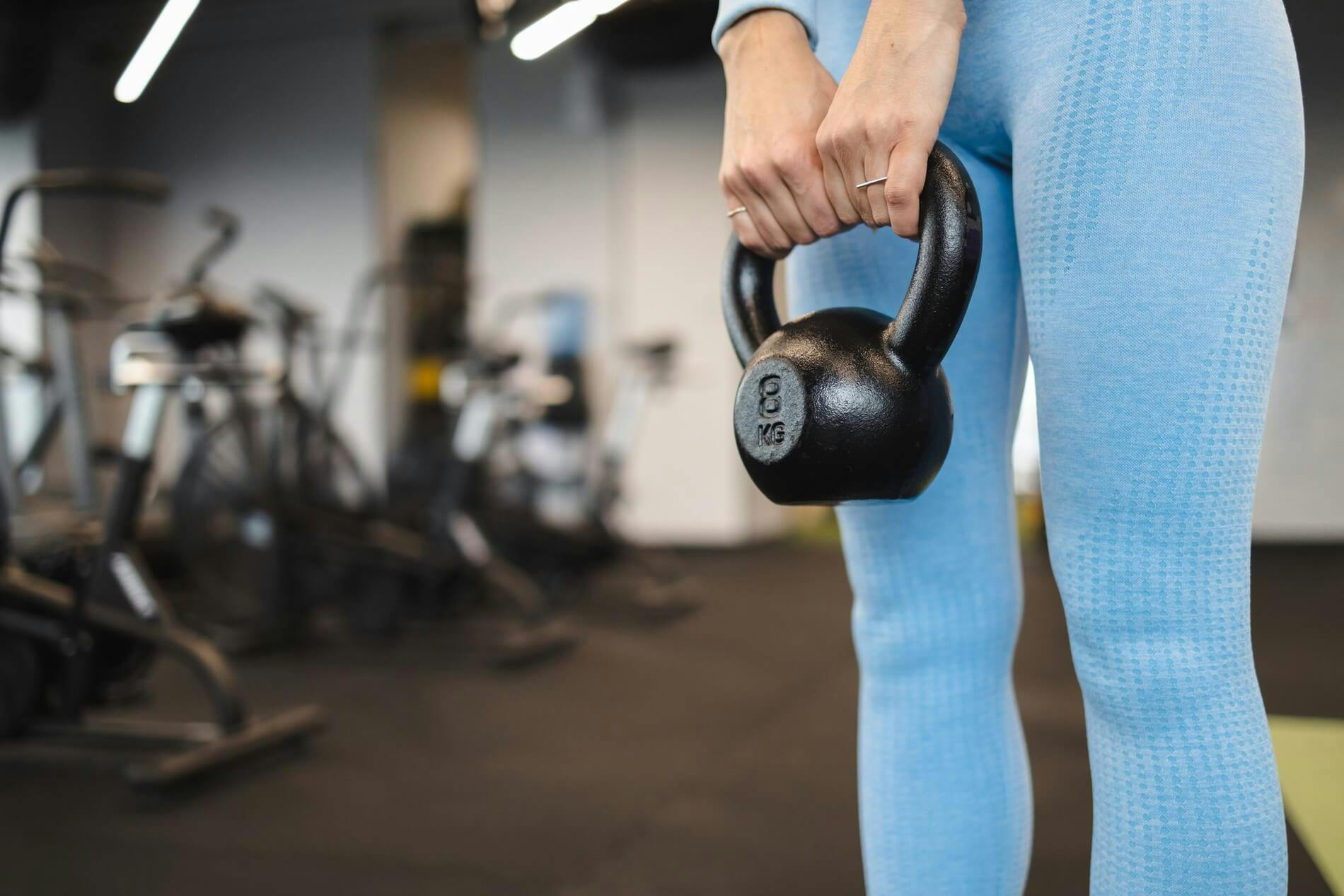 woman holding dumbbell in gym