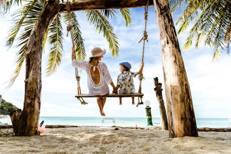 mother and child on beach swing