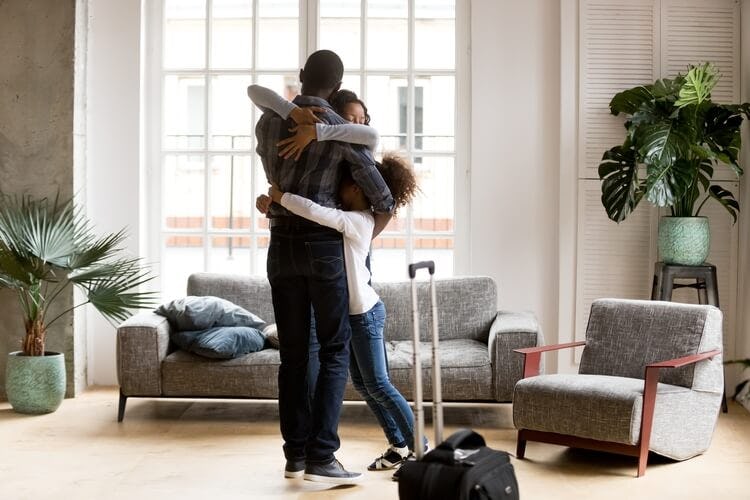a family hugging in a living room