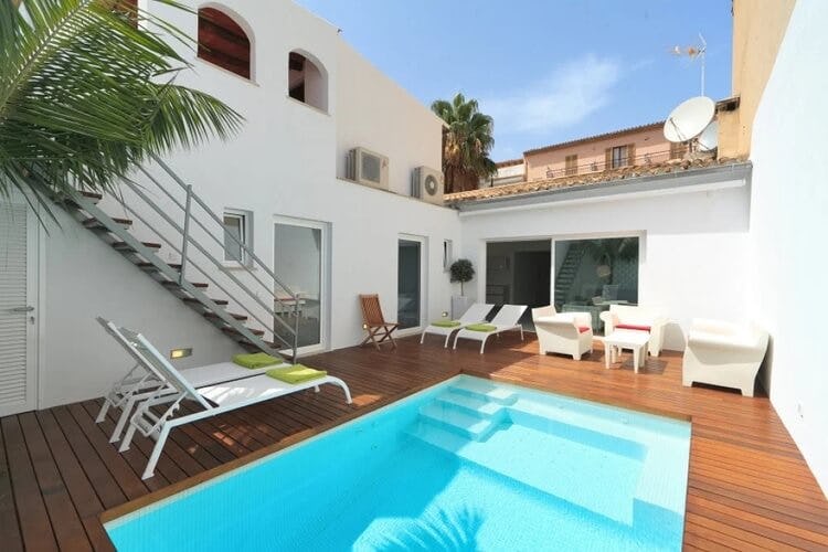 white villa with deck and pool