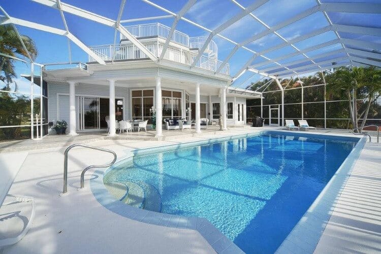 white villa with covered pool in outdoor area