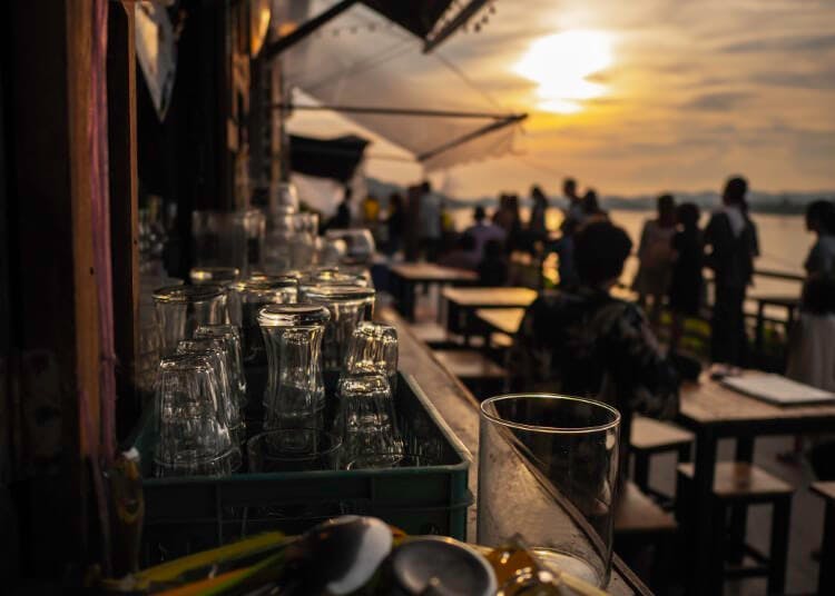 glass on bar at restaurant at sunset