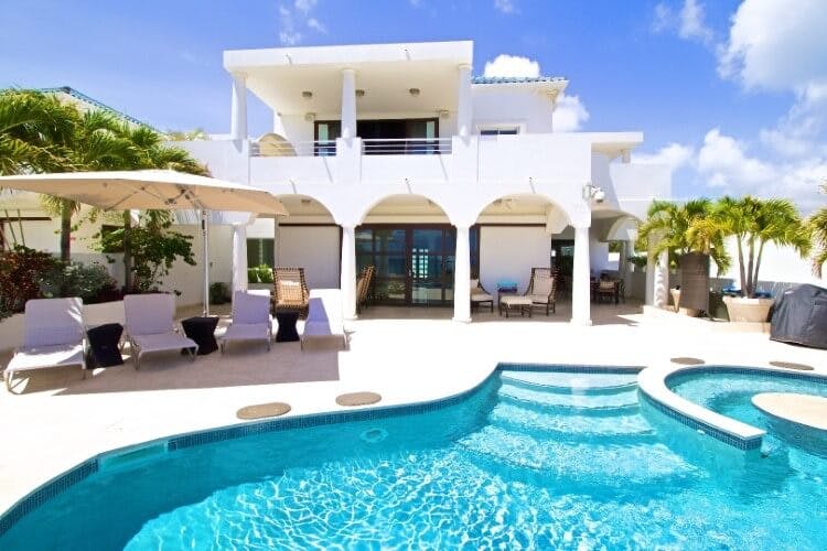 white villa with oblong pool