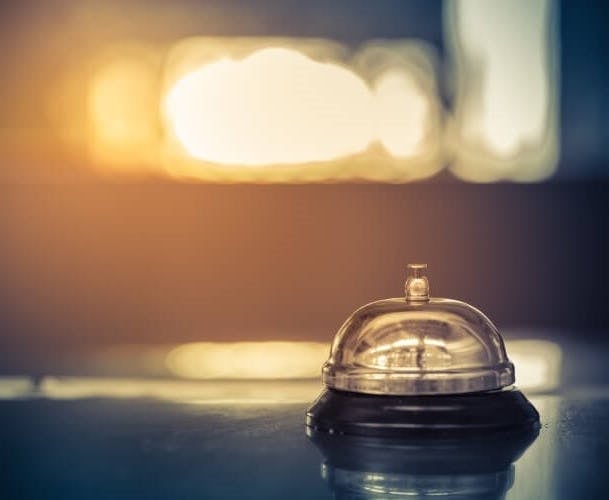 A concierge bell against a blurred bokeh background