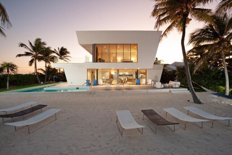 modern white villa on a beach at dusk