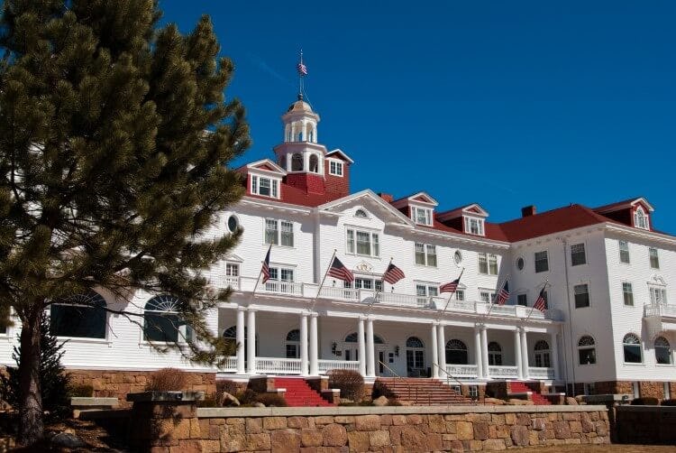 The grand white and red front of the Stanley Hotel in Estes Park