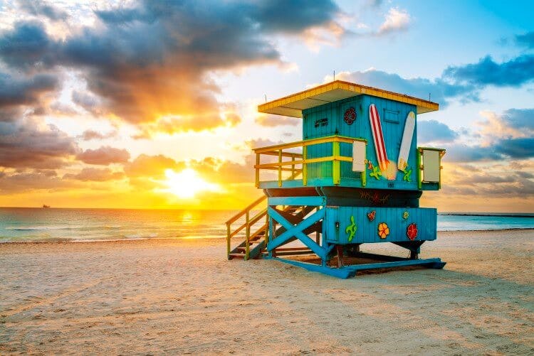 A turquoise lifeguard hut on Miami Beach at sunset