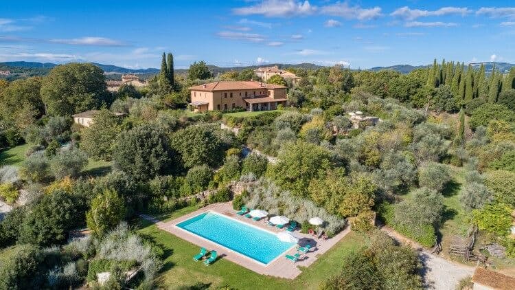 aerial view of large villa in countryside with pool