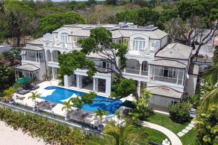a large white villa with a pool