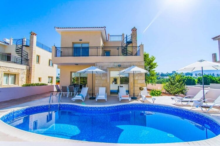 tan villa with balcony and pool