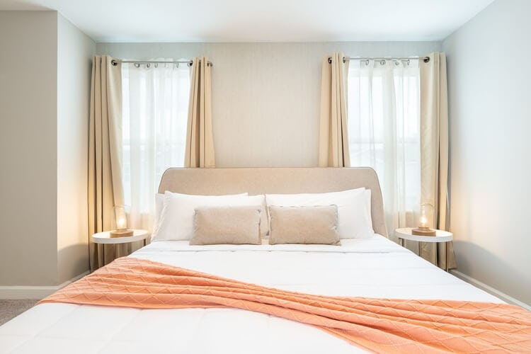 bed with orange throw