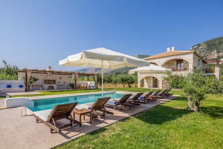 villa with lawn, pool and loungers