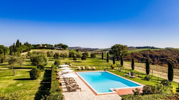 pool and patio surrounded by countryside