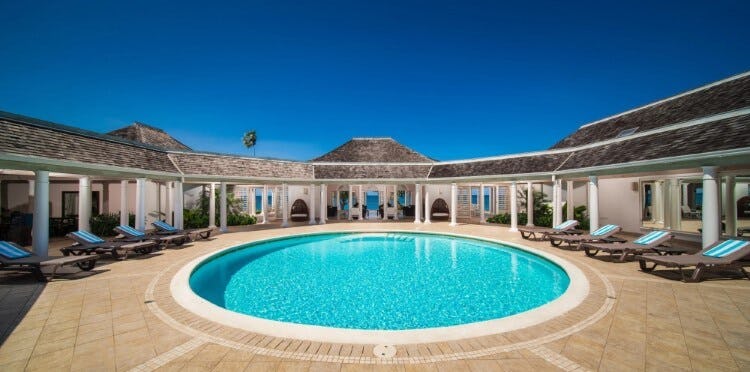 circular pool surrounded by vacation rental
