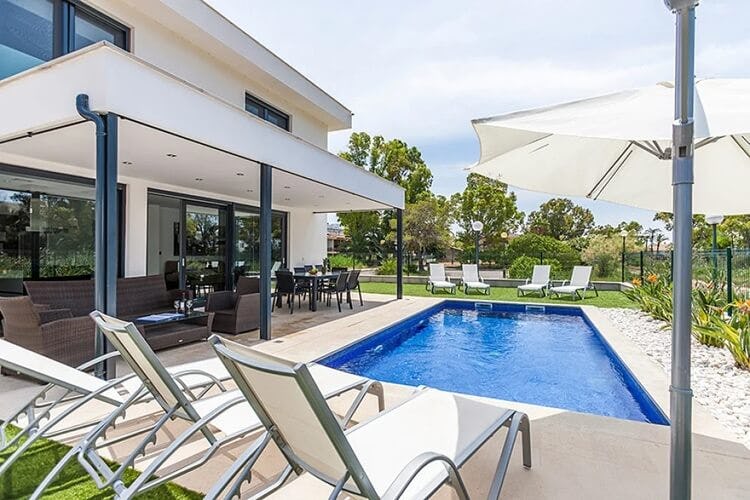 white villa with loungers and pool