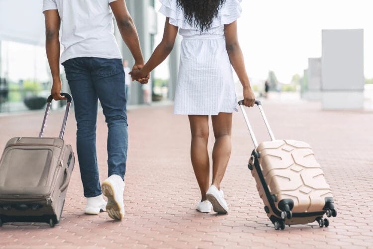 couple walking with suitcases