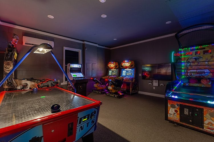 Games room in Reunion Resort 1100 vacation rental in Orlando with arcade machines and air hockey table