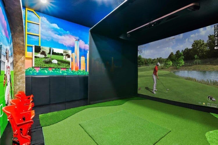 An indoor golf simulator at Villatel Village 31 vacation rental